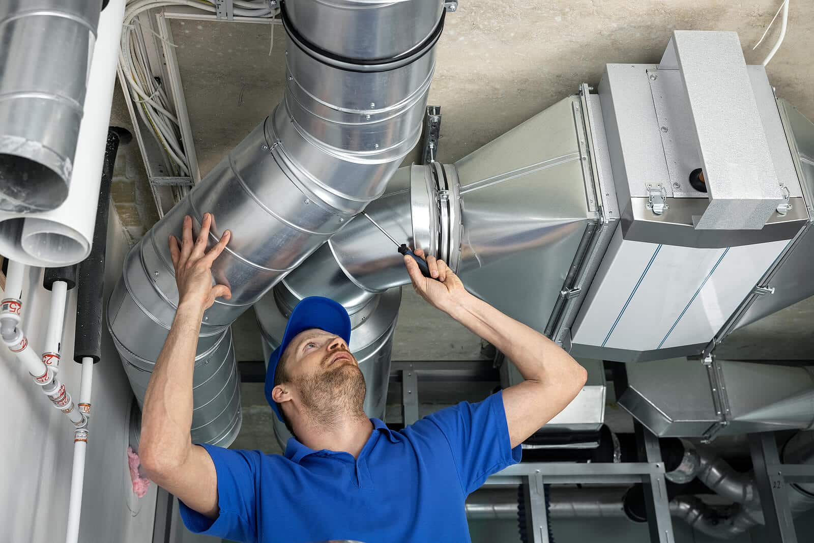 HVAC technician inspecting and repairing air ducts in Pasadena
