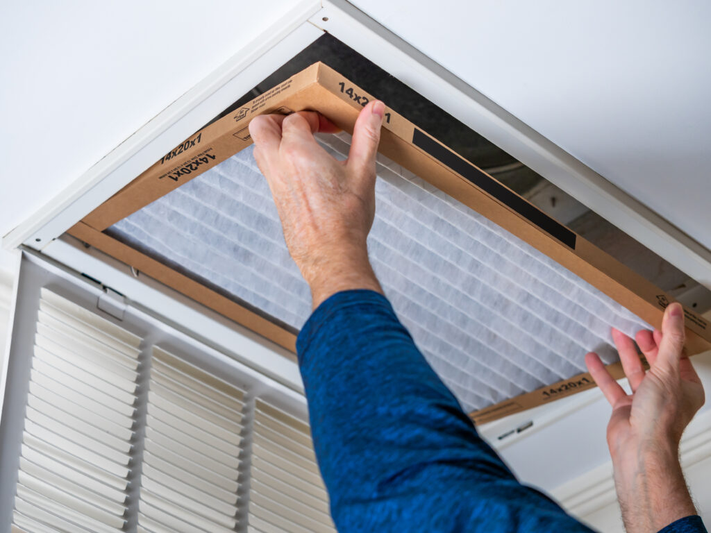 HVAC technician replacing a home air filter in Pasadena